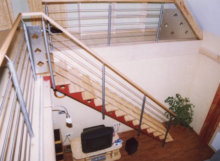 Innengeländer als Metallgeländer an einer Blechwangentreppe, diese Metalltreppe wurde mit einem Treppengeländer gesichert und gewährleistet mit ihrem Holzhandlauf den sicheren Aufgang zur Galerie